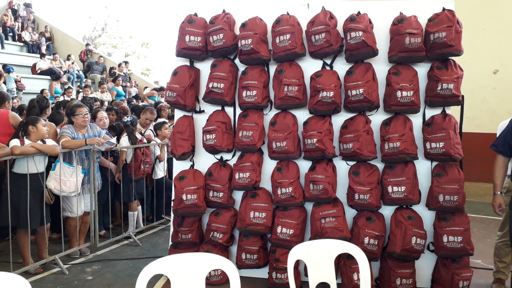Niños reciben mochilas del color de Morena por parte del DIF